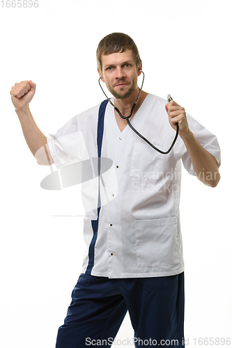 Image of Cheerful doctor funny dancing with phonendoscope phonendoscope isolated on white background