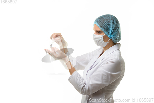 Image of Doctor picks up medicine with syringe from ampoule, isolated on white background