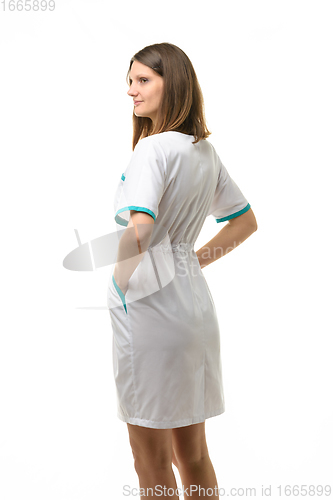 Image of Side view of girl in white medical coat, isolated on white background