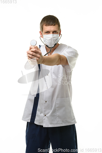 Image of Masked doctor holding head of phonendoscope in front of him, isolated on white background