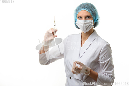 Image of Portrait of a nurse with a syringe in hand, isolated on white background