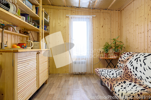 Image of Interior of a small kitchen with a set of wood in a country house