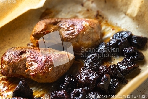 Image of Roast duck breast with plums prepared closeup