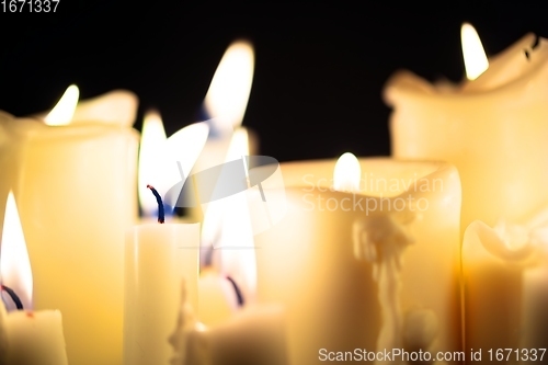 Image of Candles glowing against dark background