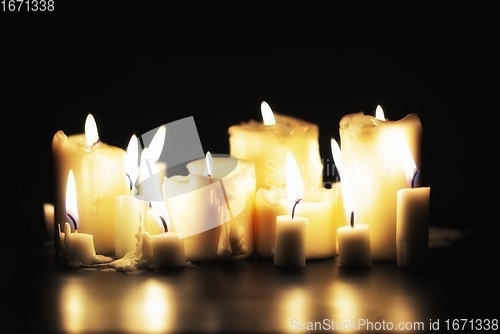 Image of Candles glowing against dark background