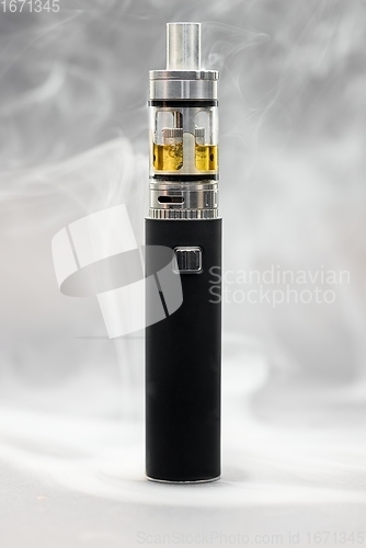 Image of Electronic cigarette against background full of smoke