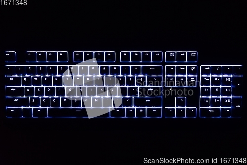 Image of Illuminated keyboard in the dark with RGB lighting