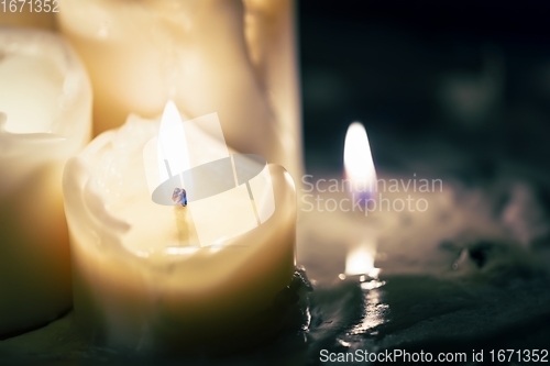 Image of Candles glowing against dark background