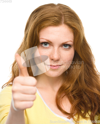 Image of Woman is showing thumb up gesture