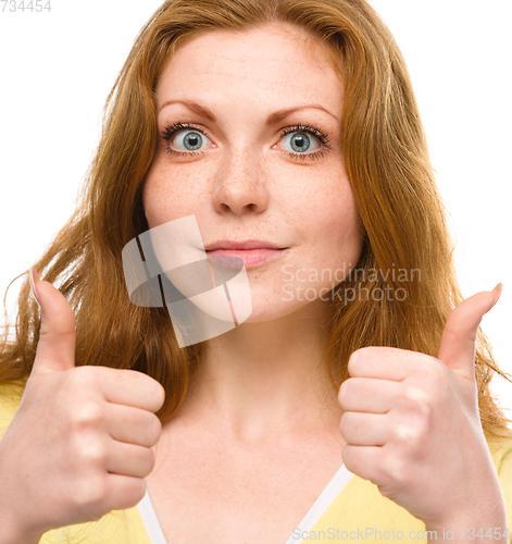 Image of Woman is showing thumb up gesture