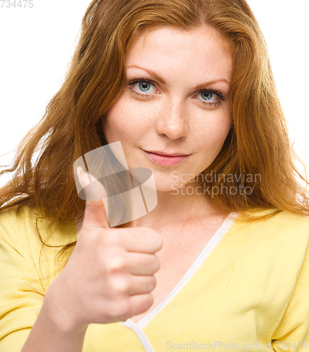 Image of Woman is showing thumb up gesture