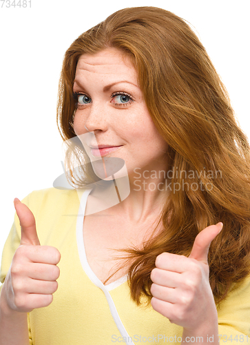 Image of Woman is showing thumb up gesture