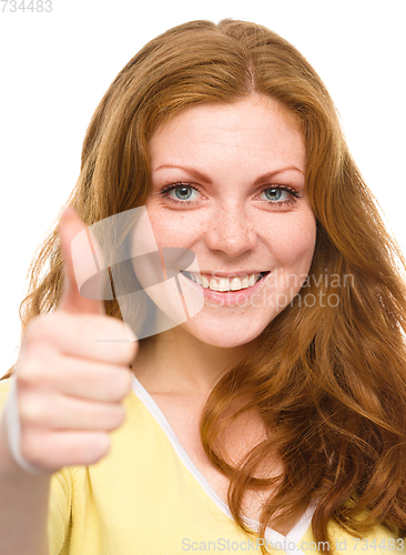 Image of Woman is showing thumb up gesture