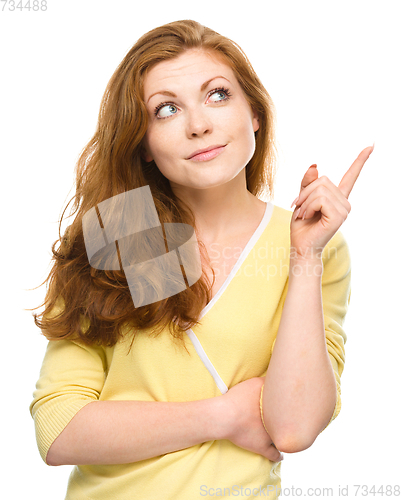 Image of Portrait of a young woman pointing to the right