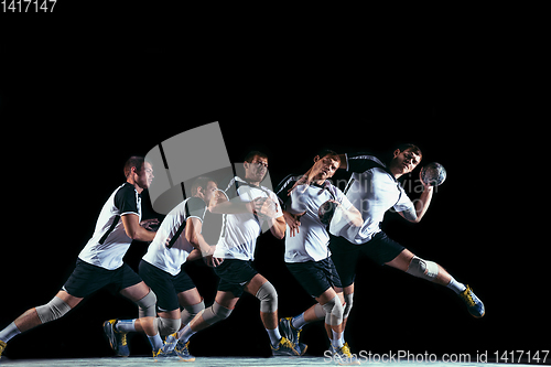 Image of Young handball player against dark studio background in strobe light