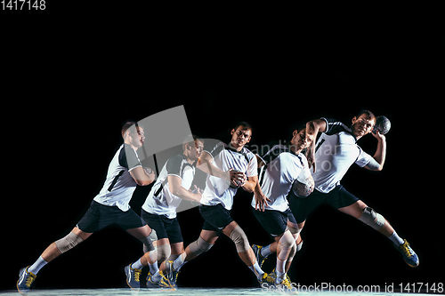 Image of Young handball player against dark studio background in strobe light