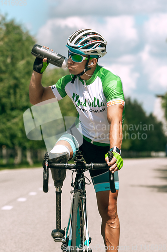 Image of Dnipro, Ukraine - July 12, 2019: athlete with disabilities or amputee training in cycling