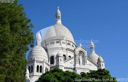Image of Dome of the Sacre Coeur basilica in Paris rises above trees 