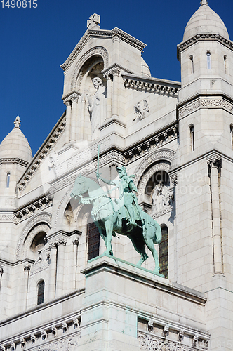 Image of Joan of Arc bronze equestrian statue on the facade of the Sacre 