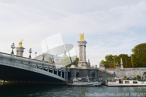 Image of Boats moored at the foot of the Pont d\'Alexandre III on the Rive