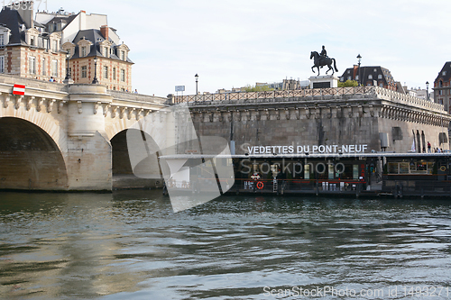 Image of Sightseeing cruise boat river station at New Bridge in Paris