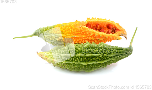 Image of Two ripe bitter melons - green and overripe orange, split open