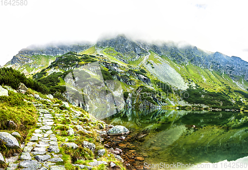Image of Tourist hiking trail along the picturesque mountain lake