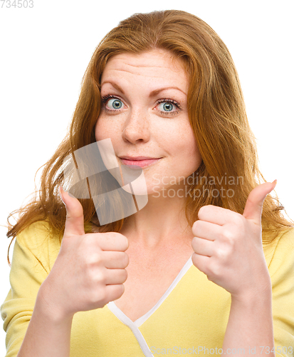 Image of Woman is showing thumb up gesture