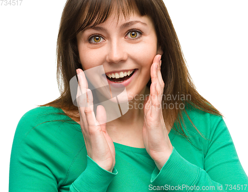 Image of Woman is holding her face in astonishment