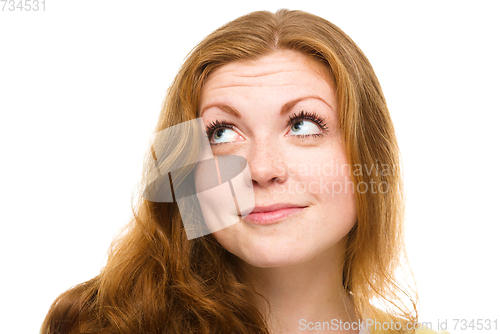 Image of Young happy woman is looking up and smile