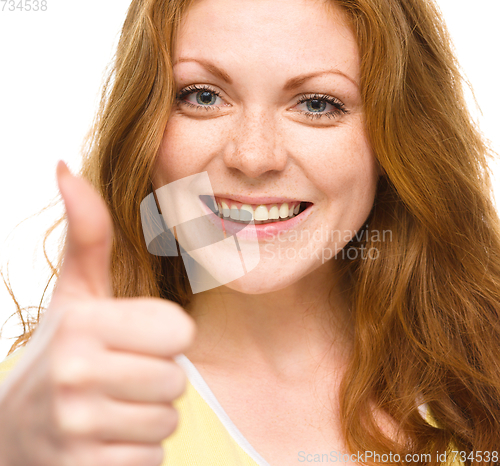 Image of Woman is showing thumb up gesture