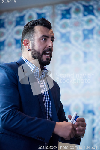 Image of successful businessman giving presentations at conference room
