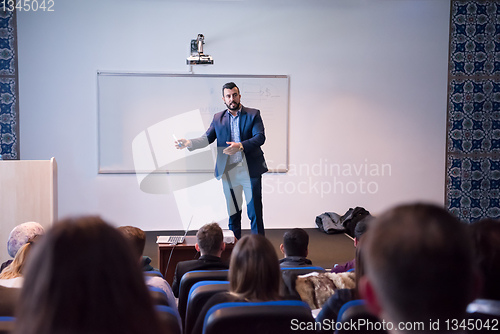 Image of successful businessman giving presentations at conference room