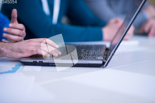 Image of business people hands using laptop computer