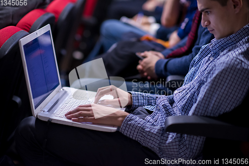 Image of businessman using laptop computer during seminar