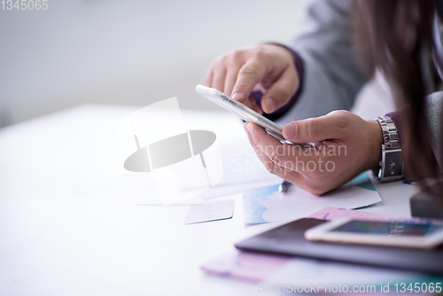 Image of Young casual businessman using smartphone