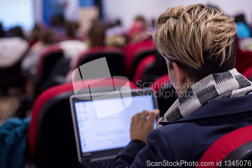 Image of businesswoman using laptop computer during seminar