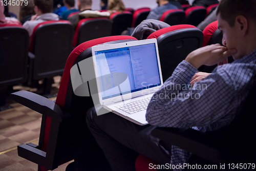 Image of businessman using laptop computer during seminar