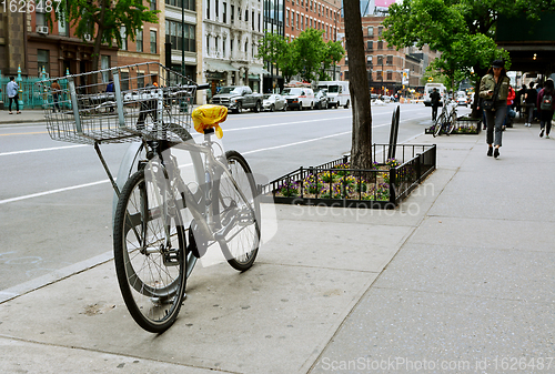 Image of Bicycle chained to a stand on West 14th Street in downtown New Y