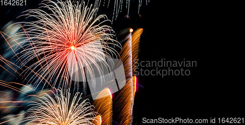 Image of Brightly Colorful Fireworks on dark sky background