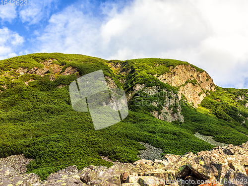 Image of Polish Tatra mountains summer landscape with blue sky and white clouds.