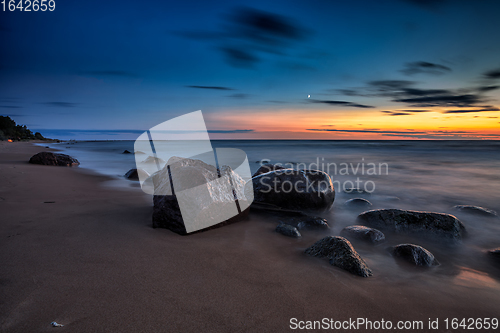 Image of Sea sunset seascape with wet rocks