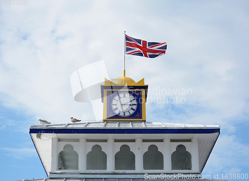 Image of The Union Jack flag flies atop the clock tower of Eastbourne pie