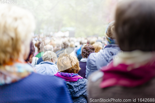 Image of Large crowd of people in city park