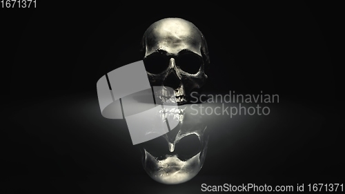 Image of Spooky dark black skull aginast dark background