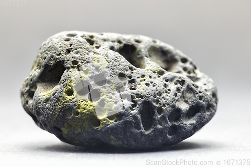 Image of Smoke whirling around small meteorite stone