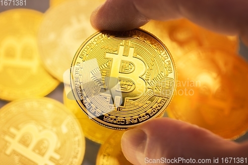 Image of Physical bitcoin held in hands closeup