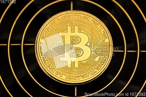 Image of Physical shiny bitcoin agains dark background