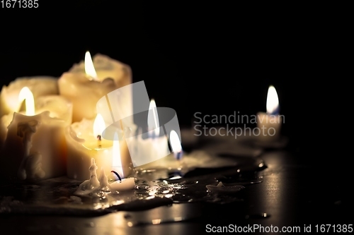 Image of Candles glowing against dark background