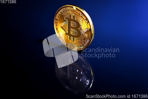 Image of Physical shiny bitcoin agains dark background